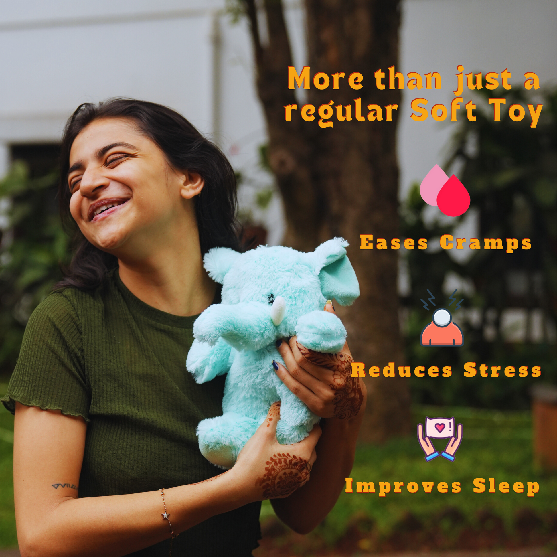 Happy woman holding a blue microwavable comfort plush elephant toy outdoors easing cramps